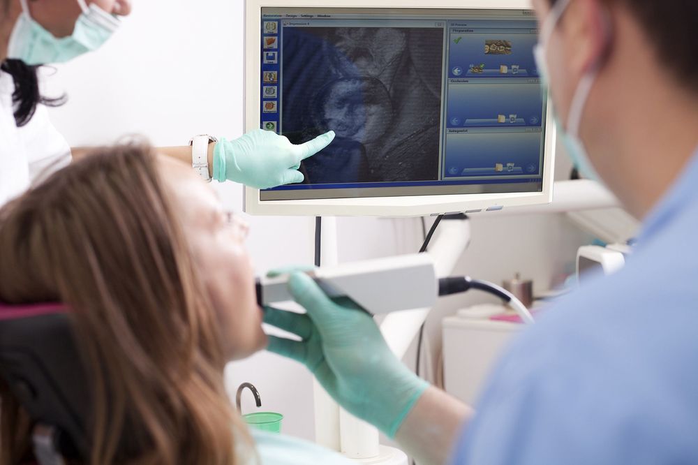 Photo of a dentist using an intraoral camera